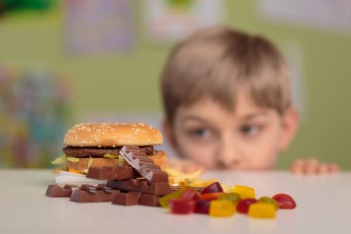 A boy looking longingly at junk food