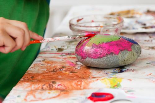 A child painting a stone