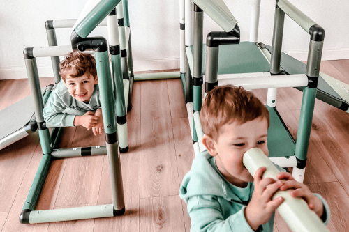 Children playing on a climbing frame with slides