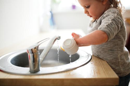 A girl washing a cup