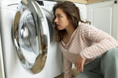 Woman in front of a washing machine