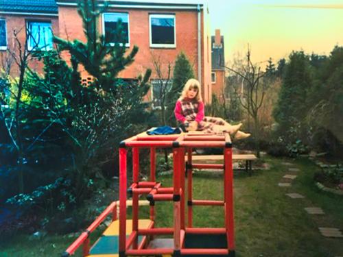 A girl on top of an old QUADRO jungle gym