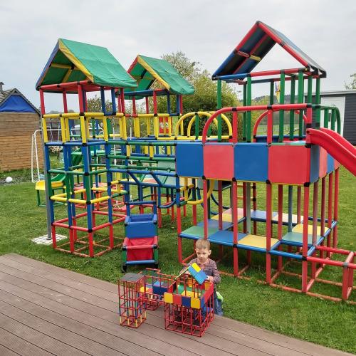 A boy with jungle gyms built with both QUADRO and miniQUADRO